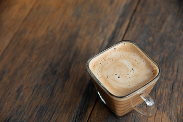 a cup of coffee on wood background