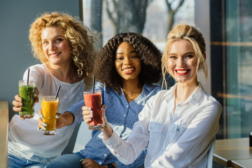 Portrait of three female are clinking glasses. close up portrait. celebration party in sunny summer...