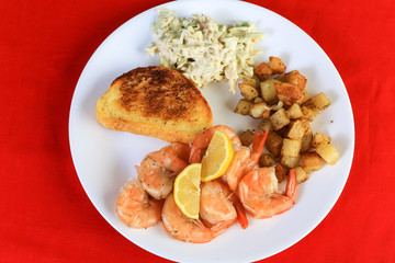 Boiled Shrimp in Shell with Coleslaw and Home Fries on Red BG