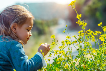 Baby enjoying flowers aroma