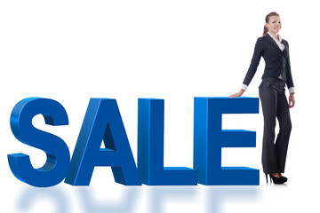 Woman standing next to SALE word