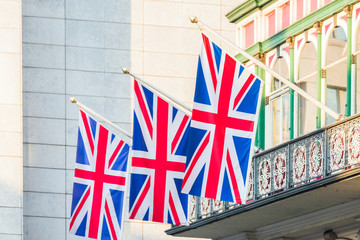 Fototapeta na wymiar United Kingdom flags hanging from a balcony. Great Britain national symbol.