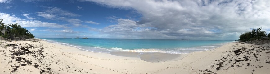 Panoramic view of a beautiful beach with gentle waves and soft white sands in the Bahamas