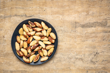 shelled Brazilian nuts on a black plate