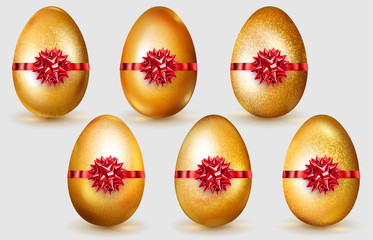 Set of realistic golden Easter eggs with red bows, glares and soft shadows on white background