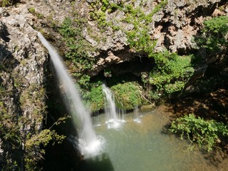Wide shot of the 77-foot waterfalls at the Natural Falls State Park, West Siloam Springs, Oklahoma taken from the view deck.