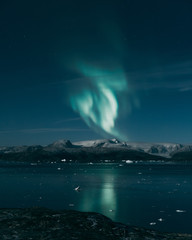 Naklejka na ściany i meble Northen light over Greenland landscape