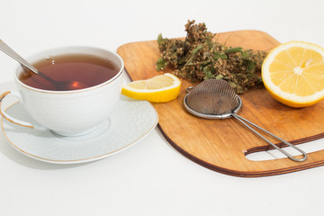 A mug of tea with lemon and chocolate.