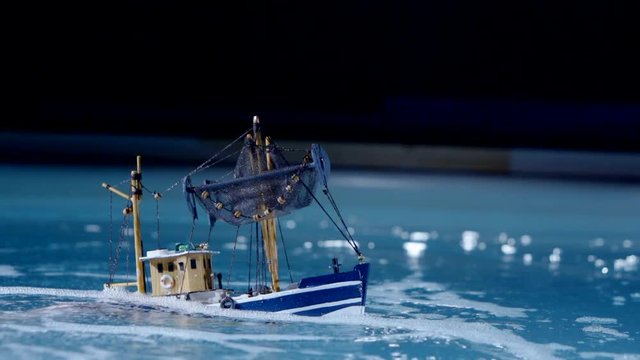 blue-and-white artificial ship sinks into the sea.