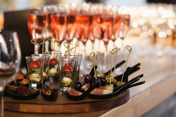 Food snack tray holiday buffet table served by different canape, sandwiches, snacks, nuts, peanuts ready for eating in restaurant