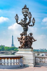 Fototapeta na wymiar Street lamp on Alexander III bridge and Eiffel Tower at background, Paris, France