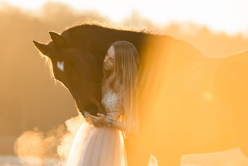 Pferd und Frau im Sonnenaufgang