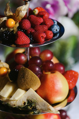 Food fruits and berries snack tray holiday buffet table served by different canape, sandwiches, snacks, nuts, peanuts ready for eating in restaurant