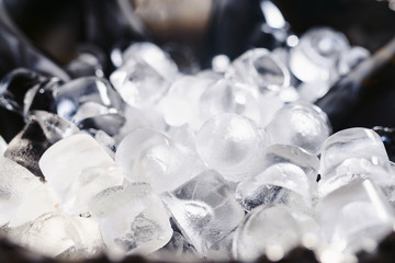 Closeup and selective focus of wine and champagne bottles chilling in a bucket full of ice. © ANR Production