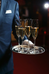 Waiter serving champagne on a tray