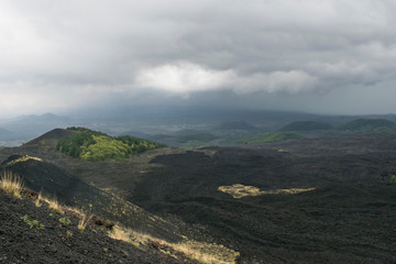 Mount Etna landscape with detail of old volcano crater slope in cloudy rainy day in September in Sicily, Italy