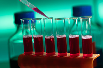 Test tube in rack and pipette media dispenser.