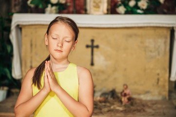 Child praying in church