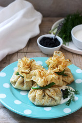 Bags of pancakes stuffed with herring, served with caviar, sour cream and dill on a wooden background. Rustic style.