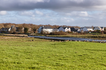 Houses, river and farm field in Clarinbridge