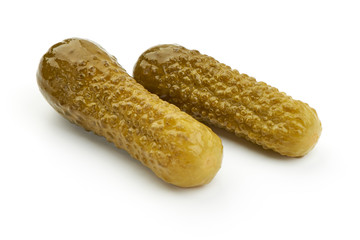 Marinated cucumbers, pickles or gherkin, salted cornichon, close-up, isolated on white background