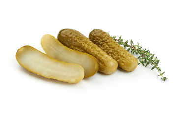 Sliced Marinated pickled cucumbers, gherkin, salted cornichon, close-up, isolated on white background