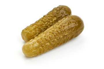 Marinated cucumbers, pickles or gherkin, salted cornichon, close-up, isolated on white background
