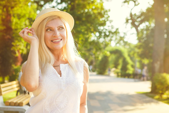 Happy mature woman at the park in summer