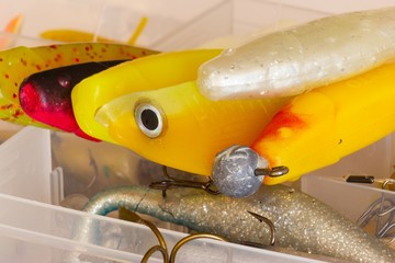 soft fishing lures on fishing tackle box close up