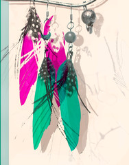 Fashion abstract art image with feather earrings in turquoise and crimson colors