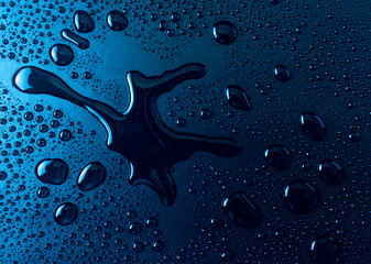 Drops of water on a blue glass texture background