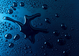 Drops of water on a blue glass texture background