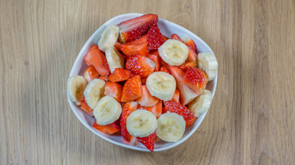 Fruit salad from fresh bananas and strawberries for a diet or healthy breakfast in sports with lots of vitamins