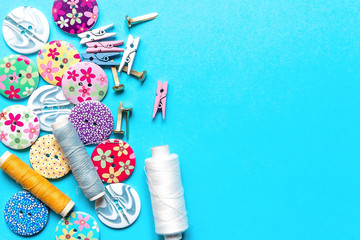 sewing thread set of sewing supplies in knolling pattern on light blue background flat lay top view, template mockup hand made