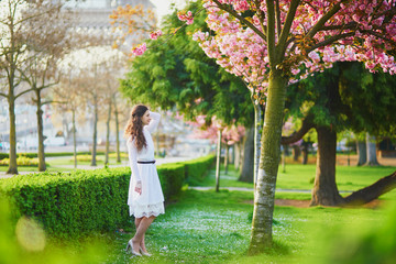 Woman enjoying cherry blossom season in Paris, France
