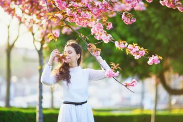 Woman enjoying cherry blossom season in Paris, France