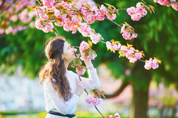 Woman enjoying cherry blossom season in Paris, France