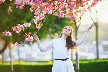Woman enjoying cherry blossom season in Paris, France