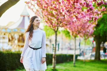 Woman enjoying cherry blossom season in Paris, France