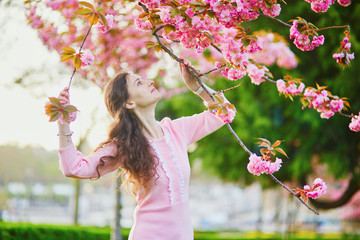 Woman enjoying cherry blossom season in Paris, France