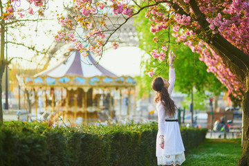 Woman enjoying cherry blossom season in Paris, France