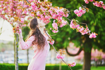 Woman enjoying cherry blossom season in Paris, France