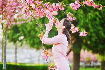 Woman enjoying cherry blossom season in Paris, France