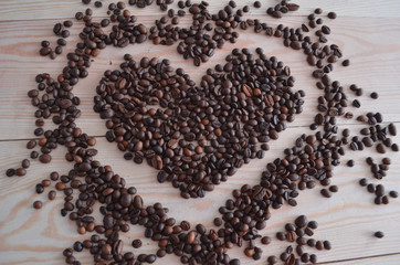 Coffee beans on wooden background.