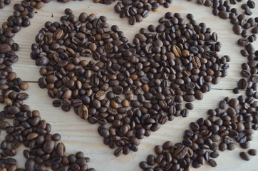 Coffee beans on wooden background.