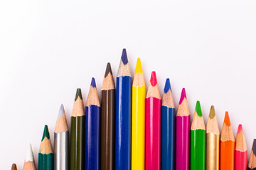 Many colorful pens in several arrangements isolated on white background