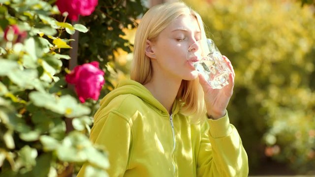 Young woman drinking water. Clean health water concet.