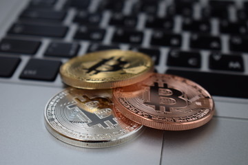 Gold currency bitcoin currency on keyboard laptop computer, electronic finance concept. Bitcoin coins. Bussiness, commercial, exchange.