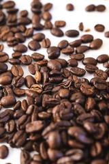 Pile of coffee beans close-up isolated on white background