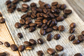Roasted coffee beans on rustic wooden boards